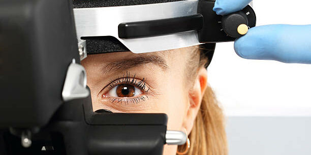 Ophthalmologist examines the eyes using a ophthalmic device Ophthalmologist examines the eyes using a ophthalmic device